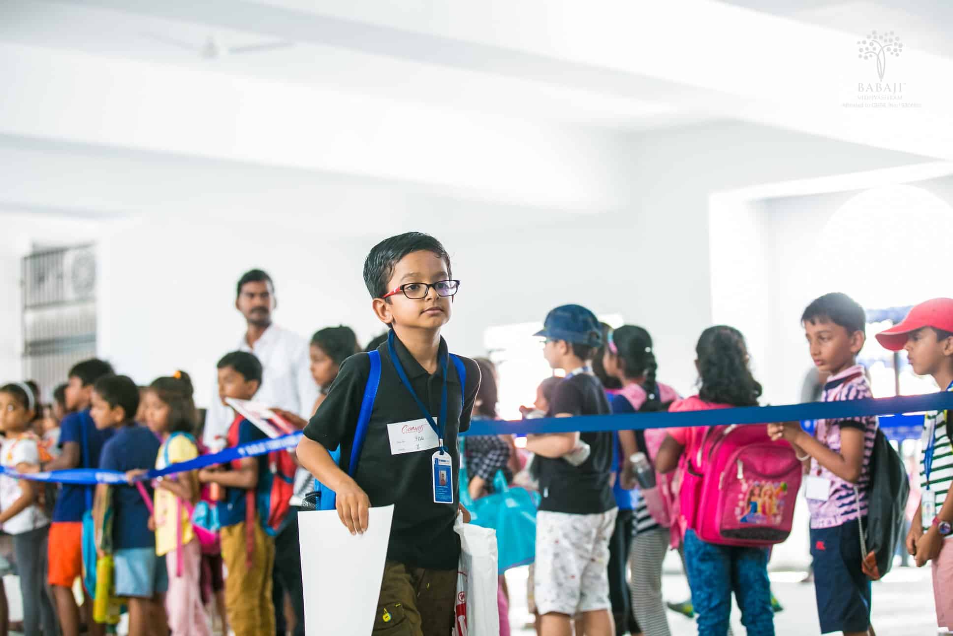 Children eagerly waiting to participate in a competition and a small boy getting ready for the competition illustrate BVS fostering Sportsmanship and team spirit.