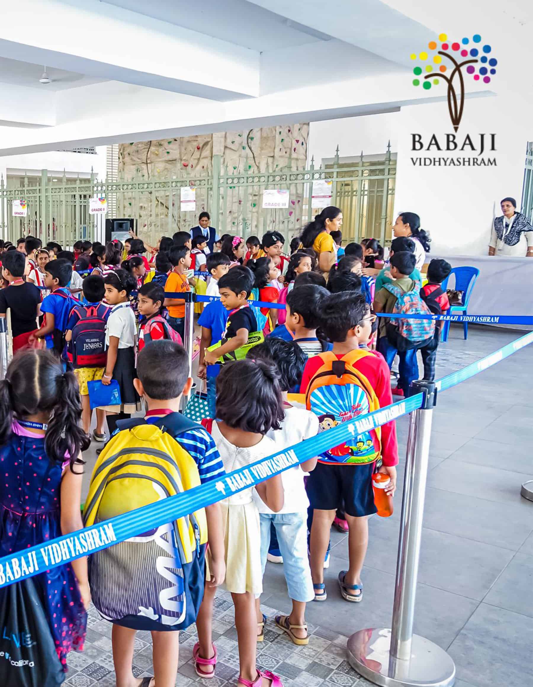 Many small  students wearing colour dress and carrying school bag on their back assembled at Babaji Vidhayashram School Reception